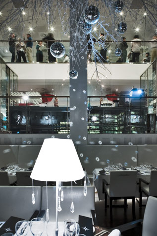 Design and decoration for Christmas theme party/event evenings at Copenhagen Island Hotel, the theme being”White Christmas”. Large 5 meter white painted branches were hung from the ceiling, glittering “disco” balls and white ornaments were suspended from the branches. White lamp shades were made to order with small sparkling crystals reflecting the light. Notice how the light bounces off the disco balls creating a magical effect in the room while the guests enjoy a drink upstairs.