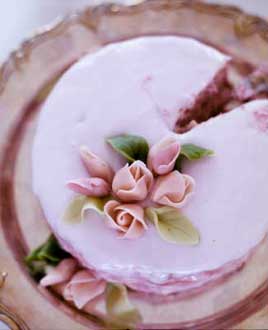 This Cake of your dreams has a base of hazelnut layer cake, a raspberry mousse filling and is topped by marzipan roses.